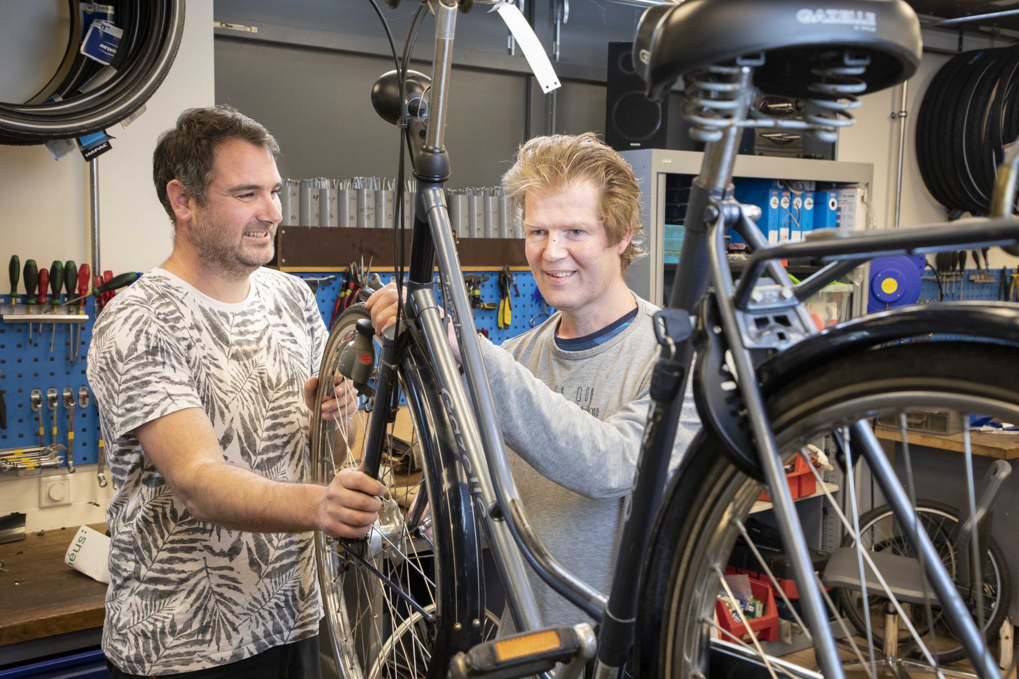 Dennis en Roel bij een te repareren fiets.